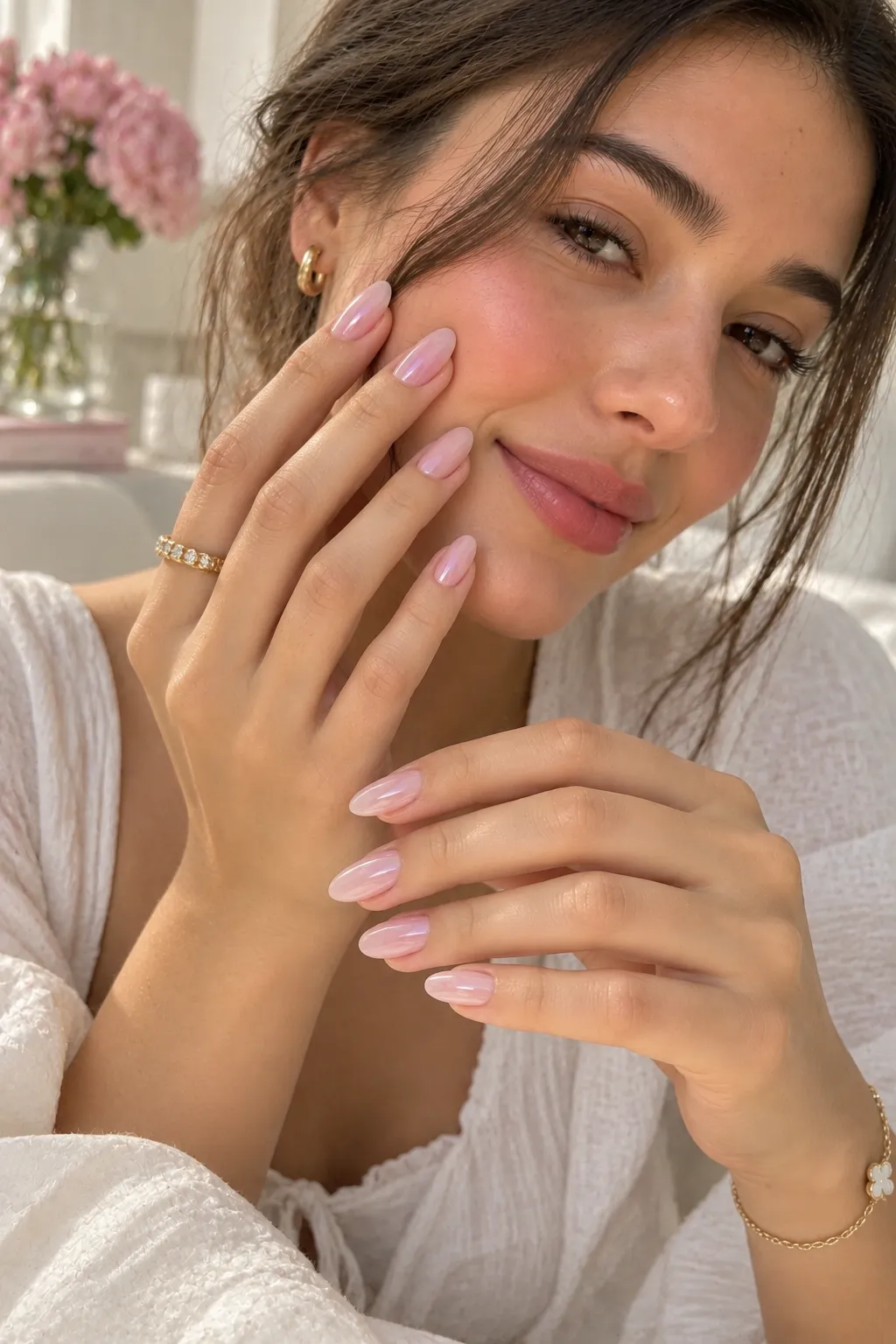 Minimalist pastel pink milk bath manicure featuring soft translucent milky pink almond-shaped nails with a clean glossy finish and natural-looking detail.