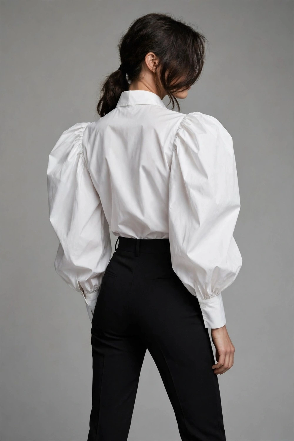 80s luxury outfit with white statement sleeve blouse and trousers