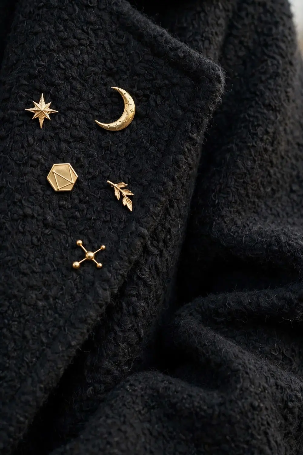 Brooch outfit idea with a constellation of gold brooches on wool coat